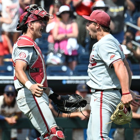 June 16: Arkansas starting pitcher Gage Wood (14) celebrates with catcher Ryder Helfrick (27) after completing a no-hitter against the Murray State Racers, the first in the College World Series in 65 years.
