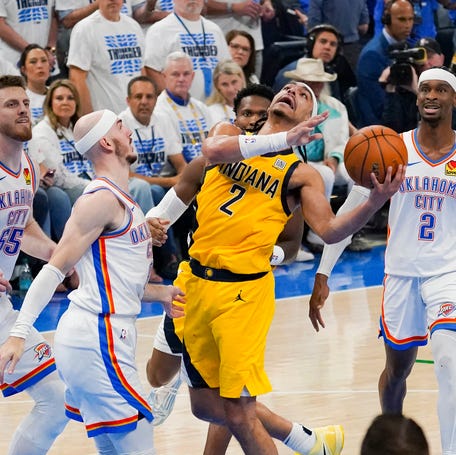Game 5: The Indiana Pacers' Andrew Nembhard (2) collides with the Oklahoma City Thunder's Alex Caruso.