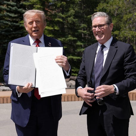 President Donald Trump holds a signed US-UK trade deal next to British Prime Minister Keir Starmer as they speak to reporters during the Group of Seven (G7) Summit at the Pomeroy Kananaskis Mountain Lodge in Kananaskis, Alberta, Canada on June 16, 2025.
