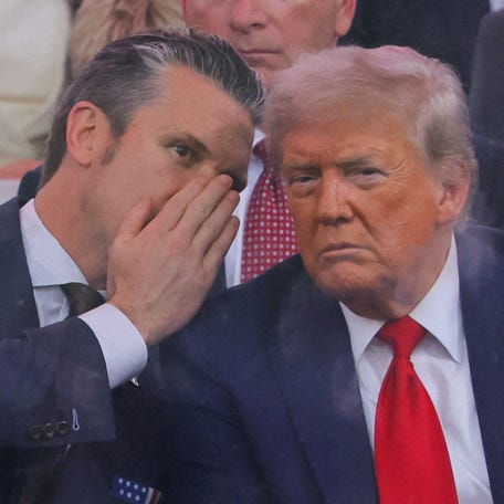 U.S. Secretary of Defense Pete Hegseth talks to U.S. President Donald Trump during the U.S. Army's 250th Birthday parade, on the same day of U.S. President Donald Trump 79th birthday, in Washington, D.C., U.S., June 14, 2025.