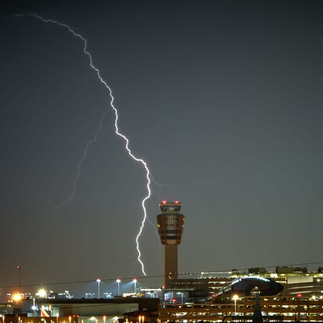 Lightning strikes in the skies behind Phoenix Sky Harbor International Airport as seen from the roof of the IDEA Tempe Parking Garage on Monday, Aug. 21, 2023. Alex Gould/Special for The Republic