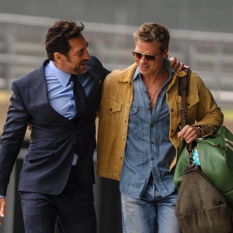 Apex F1 team owner Ruben Cervantes (Javier Bardem, left) greets his old racing pal Sonny Hayes (Brad Pitt) as the two team up to try and save the fortunes of a flagging F1 team in "F1 The Movie."