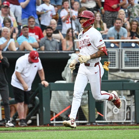 Jun 17, 2025; Omaha, Neb, USA; Arkansas Razorbacks shortstop Wehiwa Aloy (9) circles the bases after hitting a home run against the UCLA Bruins during the first inning at Charles Schwab Field. Mandatory Credit: Steven Branscombe-Imagn Images