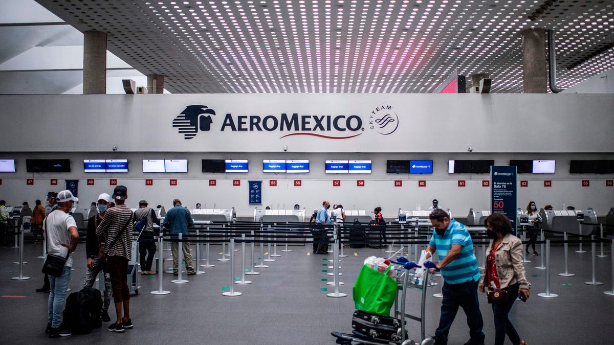 Passengers wait at the counters of Aeromexico, at Mexico City's International Airport.