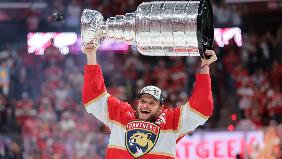Florida Panthers center Aleksander Barkov (16) hoists the Stanley Cup after winning Game 6.