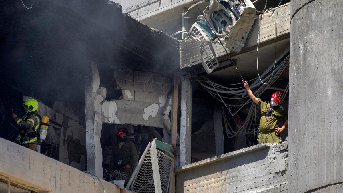 First responders inspect a heavily-damaged building at Soroka Hospital in Beersheba in southern Israel following an Iranian missile attack on June 19, 2025. The hospital was hit during a barrage of "dozens" of Iranian missiles on June 19, officials said.