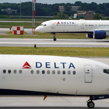 A Delta Air Lines flight from Atlanta to Miami flight taxis to the runway as another plane prepares for takeoff at Hartsfield-Jackson International Airport on Jun 30, 2022.