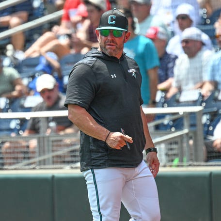 Coastal Carolina Chanticleers head coach Kevin Schnall looks to the field during the game against the Arizona Wildcats during the fifth inning at Charles Schwab Field on Jun 13, 2025 in Omaha, Nebraska.