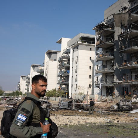A member of the Israeli security forces checks the destruction at site of an Iranian missile attack in Beersheba in southern Israel, on June 20, 2025. Israel and Iran exchanged fire again on June 20, a week into the war between the longtime enemies.