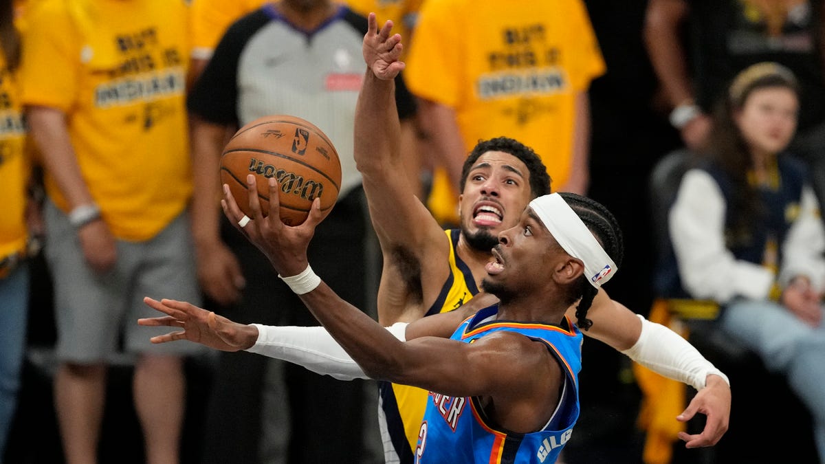 Thunder guard Shai Gilgeous-Alexander (2) shoots the ball against Pacers guard Tyrese Haliburton (0) during the first half of Game 3 of the NBA Finals at Gainbridge Fieldhouse in Indianapolis on June 11, 2025.