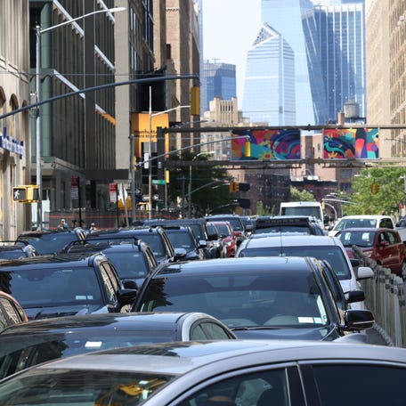 NEW YORK, NEW YORK - JULY 03: Drivers wait in traffic to enter the Holland Tunnel on the eve of the Fourth of July on July 03, 2024 in New York City.
