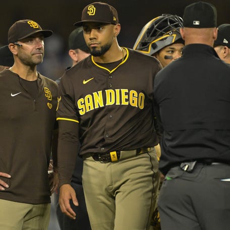 San Diego Padres bench coach Brian Esposito (82) looks on as pitcher Robert Suarez (75) is ejected from the game after hitting Los Angeles Dodgers star Shohei Ohtani (17) with a pitch in the ninth inning at Dodger Stadium in Los Angeles, California on June 19, 2025.