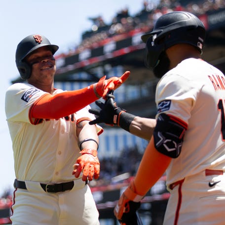 San Francisco Giants DH Rafael Devers (16) celebrates with Heliot Ramos (17) after hitting a two-run home run against the Boston Red Sox.