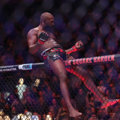 Jon Jones celebrates defeating Stipe Miocoic in a heavyweight bout at UFC 309.
