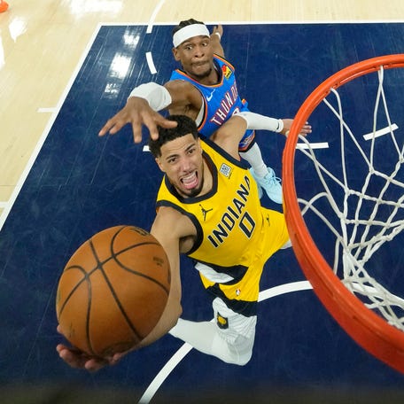 Indiana Pacers guard Tyrese Haliburton (0) drives to the basket while Oklahoma City Thunder guard Shai Gilgeous-Alexander (2) defends during the second half of Game 4.