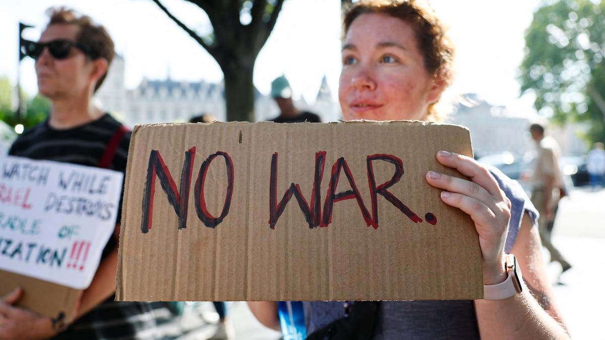 Protesters hold banners as Iranians in Paris demonstrate following the U.S attack on Iran's nuclear sites on June 22, 2025.