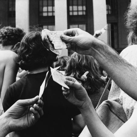 Anti-Vietnam war protesters demonstrate by burning military draft cards in front of the Pentagon in Washington on May 22, 1972.