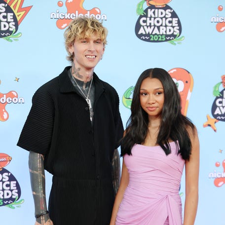 Machine Gun Kelly, left, and Casie Baker attend the Nickelodeon Kids' Choice Awards at Barker Hangar in Santa Monica, California, on June 21, 2025.