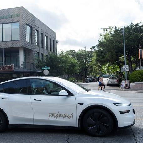 A Tesla robotaxi drives on the street along South Congress Avenue in Austin, Texas, June 22, 2025.