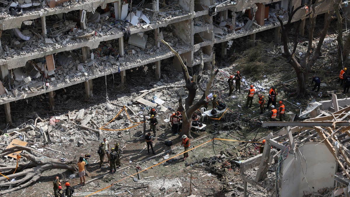 Emergency personnel work at a site hit by a missile from Iran in Tel Aviv, Israel, on June 22, 2025.