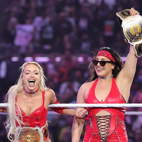 Liv Morgan (left) and Raquel Rodriguez are introduced prior to their match against Lyra Valkyria and Becky Lynch for the Women's Tag Team Championship during WrestleMania 41 at Allegiant Stadium on April 20, 2025 in Las Vegas, Nevada.