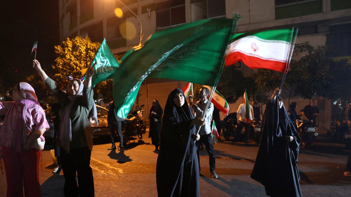 A group of Iranians celebrate following Iran's attack on U.S. military base in Qatar, amid the Iran-Israel conflict, in Tehran, Iran, on June 23, 2025.