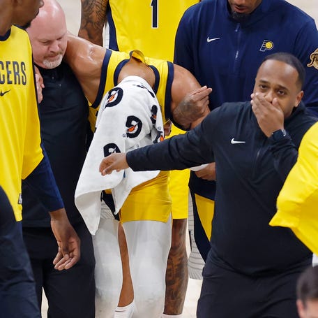 Indiana Pacers guard Tyrese Haliburton (0) is assisted after an apparent injury following a play against the Oklahoma City Thunder during the first half of game seven of the 2025 NBA Finals at Paycom Center.