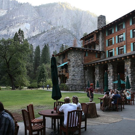 Park visitors sit outside of the Ahwahnee Hotel on August 28, 2013 in Yosemite National Park, California.