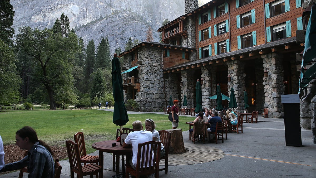 Park visitors sit outside of the Ahwahnee Hotel on August 28, 2013 in Yosemite National Park, California.