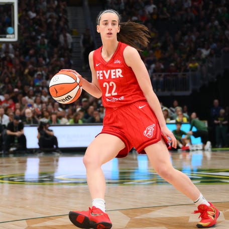 Indiana Fever guard Caitlin Clark (22) dribbles the ball against the Seattle Storm during the second half at Climate Pledge Arena.