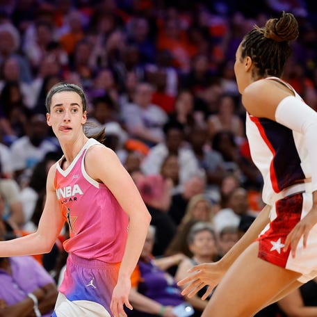 PHOENIX, ARIZONA - JULY 20: Caitlin Clark #22 of Team WNBA passes around Napheesa Collier #11 of Team USA during the first half of the 2024 WNBA All Star Game at Footprint Center on July 20, 2024 in Phoenix, Arizona. (Photo by Alex Slitz/Getty Images)