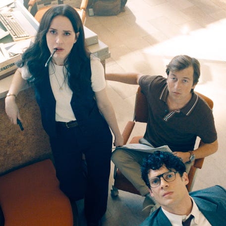 Daily Planet journalists Lois Lane (Rachel Brosnahan far left), Jimmy Olsen (Skyler Gisondo) and Clark Kent (David Corenswet) keep an eye on the TV in "Superman."