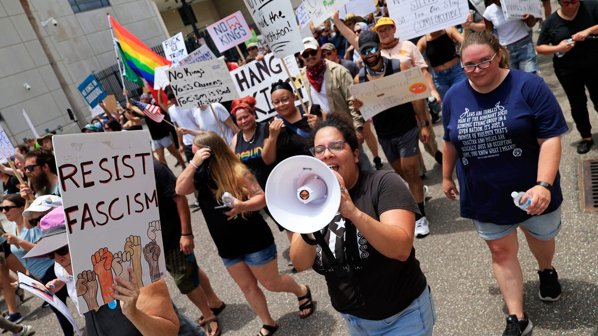 Maria Garcia of Jacksonville Immigrant Rights Alliance leads a protest march during a "No Kings" protest outside the Duval County Courthouse Saturday, June 14, 2025 in Jacksonville, Fla. People took part in one of nearly 2,000 nationwide rallies against Trump and his administration.