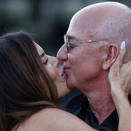 Amazon founder Jeff Bezos and his wife Lauren Sánchez Bezos kiss in Venice, Italy, June 28, 2025, as they leave Aman Venice hotel, on the third day of their wedding festivities.