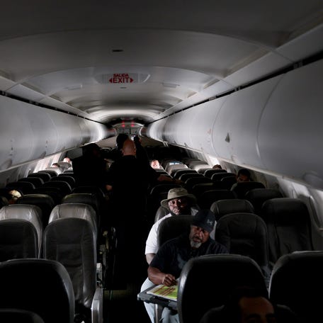 Air Marshalls and Security Officials walk around the cabin of a plane on June 26, 2025.