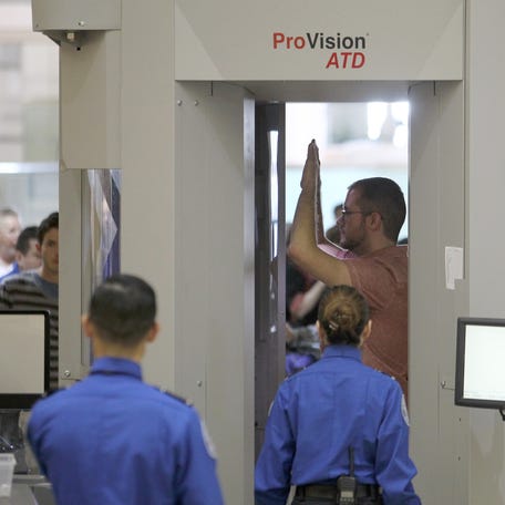 An air traveler stands in a full-body scanner at Los Angeles International Airport (LAX).