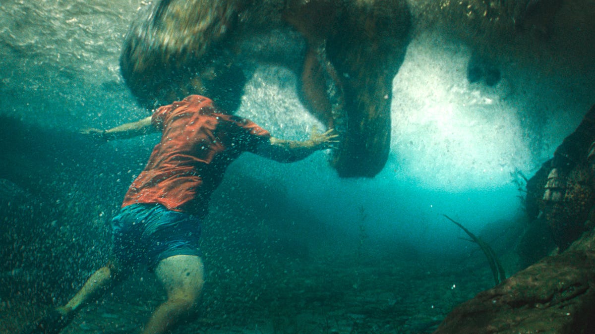T. rex hits the water for a human snack in "Jurassic World Rebirth."