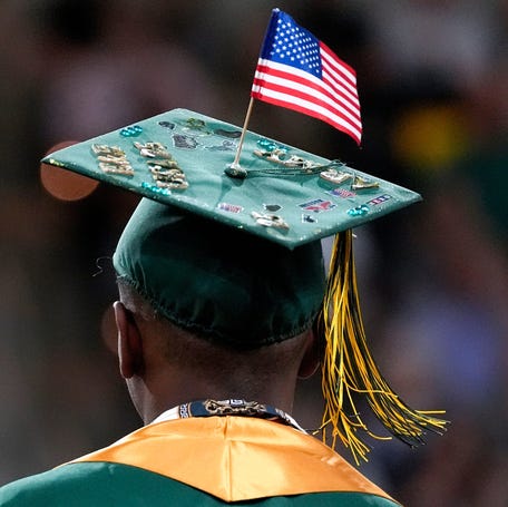 A graduate wears a cap featuring an American flag on June 1, 2025, in Iowa City.
