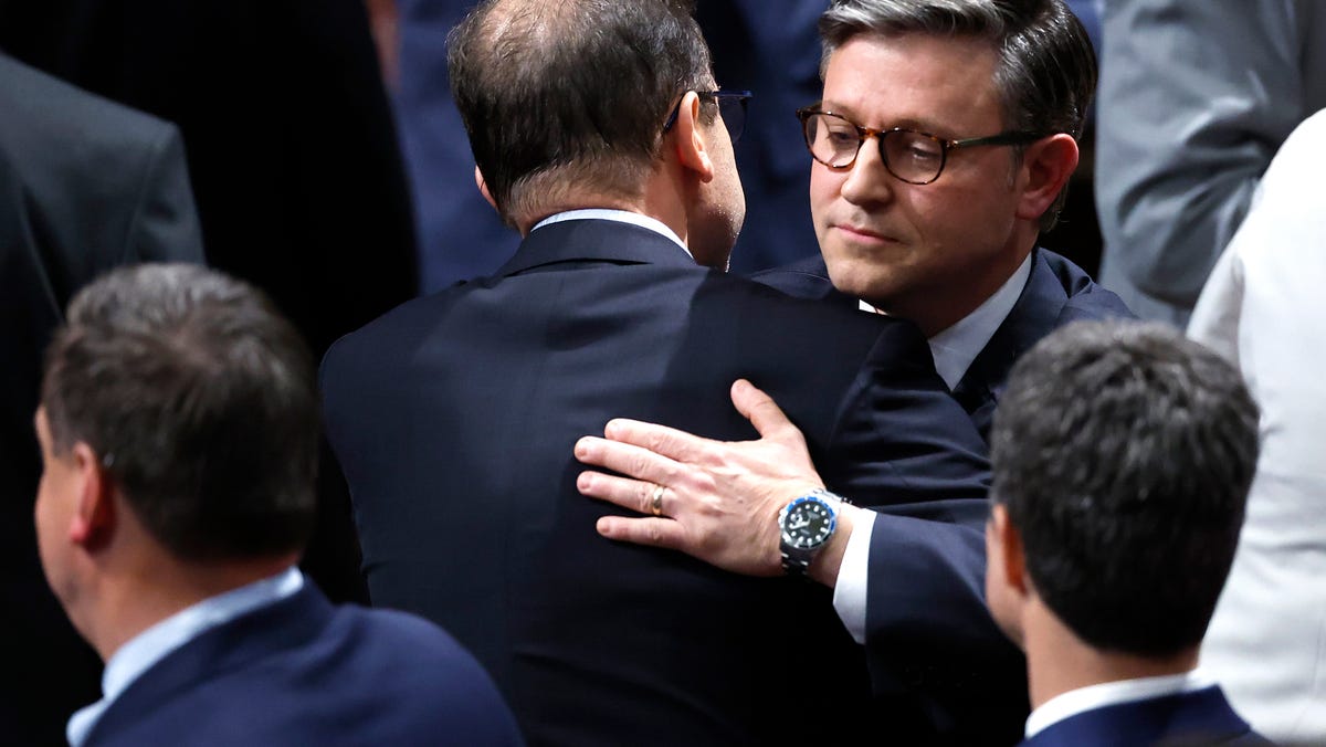 Speaker of the House Mike Johnson (R-LA) hugs a fellow members as the House of Representatives meets to vote on H.R. 1, the One, Big, Beautiful Bill Act in the House of Representatives at the U.S. Capitol on July 3, 2025 in Washington, D.C. The House is voting on the sweeping tax and spending bill after days of negotiating with Republican holdouts. The bill will make President Donald Trump's 2017 tax cuts permanent, increase spending on defense and immigration enforcement and   temporarily cut taxes on tips, while at the same time cutting funding for Medicaid, food assistance for the poor, clean energy and raises the nation's debit limit by $5 trillion.