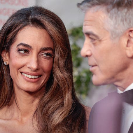 Amal Clooney looks at husband George Clooney as they attend the 78th Tony Awards at Radio City Music Hall in New York City on June 8, 2025.