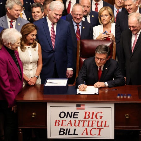 House Speaker Mike Johnson signs President Donald Trump's sweeping budget bill on July 3.