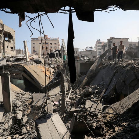 Palestinians inspect the site of Thursday's Israeli strike that damaged and destroyed residential buildings, at Shati (Beach) refugee camp, in Gaza City, July 4, 2025. REUTERS/Mahmoud Issa