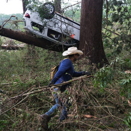 A man searches the area, following flash flooding, in Hunt, Texas, on July 6, 2025.