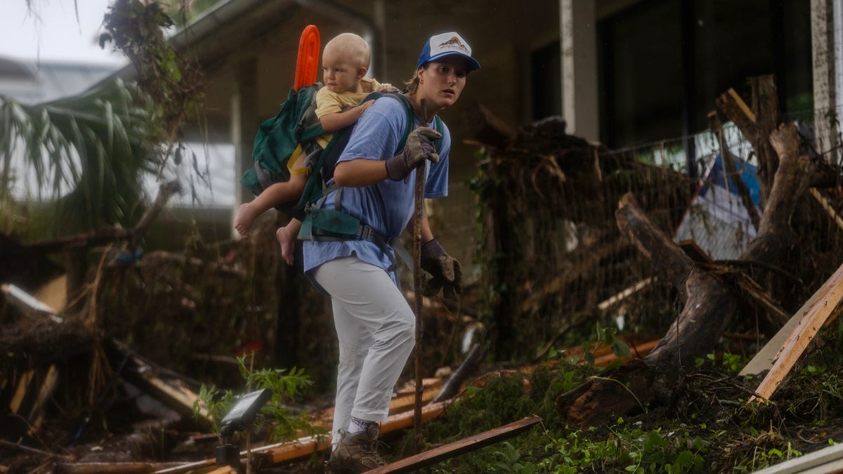 A search and rescue worker looks through debris for any survivors or remains of people swept up in the flash flooding on July 6, 2025 in Hunt, Texas. Heavy rainfall caused flooding along the Guadalupe River in central Texas with multiple fatalities reported.