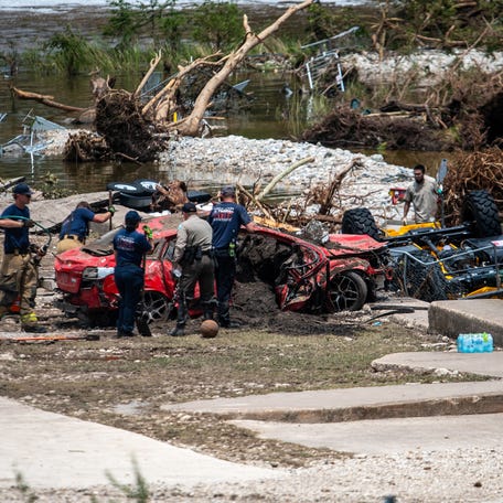 First responders attend to a vehicle pulled from the water in the aftermath of deadly flooding in Kerrville, Texas, on July 6, 2025.