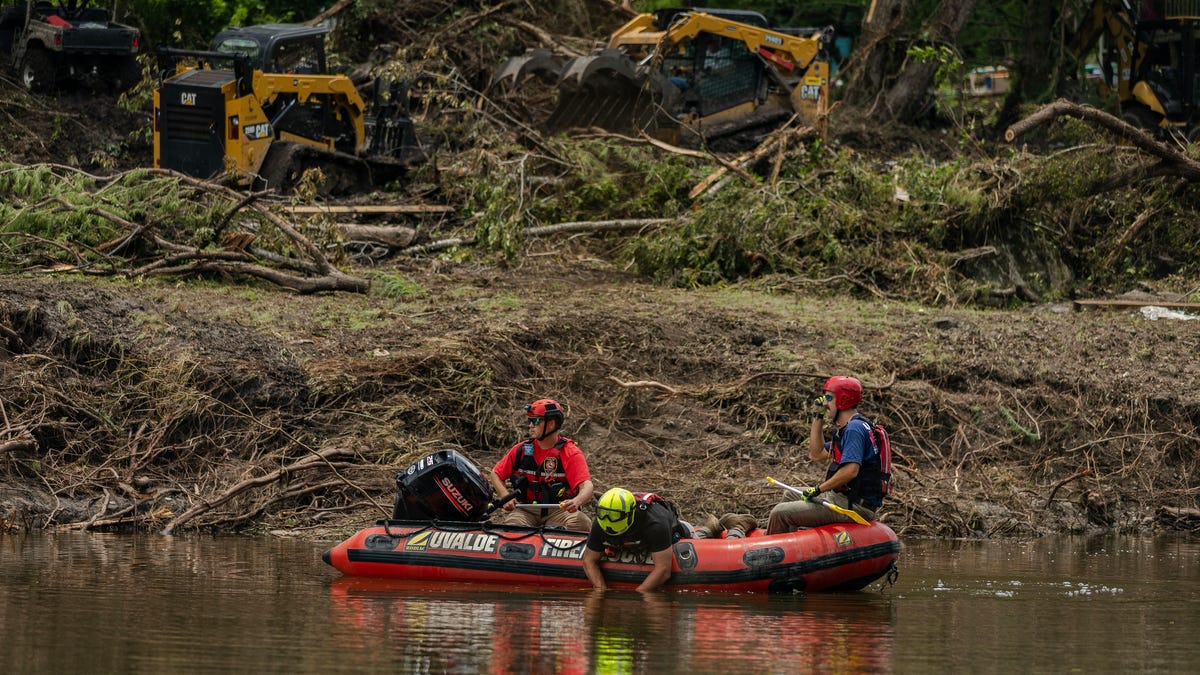 Search and rescue workers use a sonar device while paddling down the Guadalupe River in a boat looking for survivors or the remains of victims swept up in the flash flooding on July 7, 2025 in Hunt, Texas. Heavy rainfall early Friday caused severe flash flooding along the Guadalupe River in central Texas.