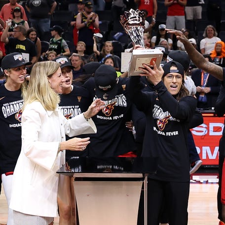 WNBA Commissioner Cathy Engelbert presents the Commissioner Cup trophy to Indiana Fever head coach Stephanie White after the game against the Minnesota Lynx at Target Center in Minneapolis on July 1, 2025.