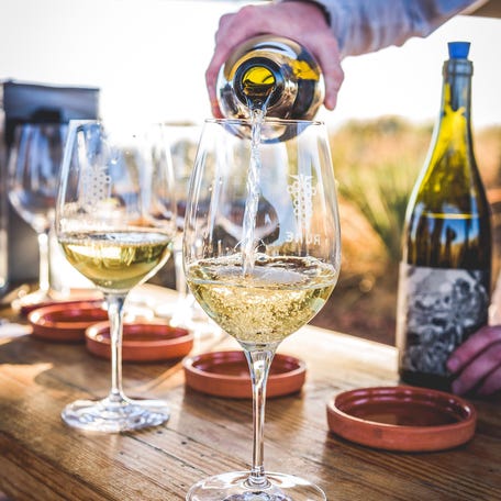 Glasses of Chardonnay are poured at Rune Outdoor Tasting Bar at Rune Wines in Sonoita, Ariz.