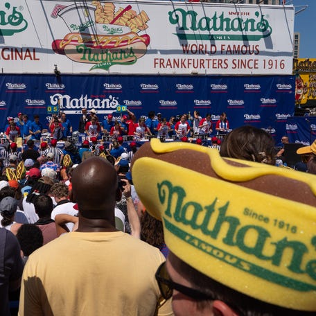 People compete in the women's competition at Nathan's Annual Hot Dog Eating Contest on July 4, 2025 in New York City.