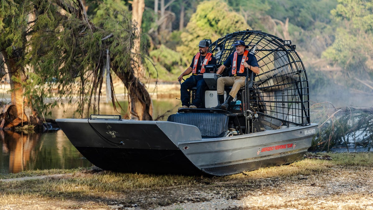 A search and recovery team launches a fan boat on Guadalupe River while in search of remains of people who were swept up in the flash flooding on July 8, 2025 in Ingram, Texas. \